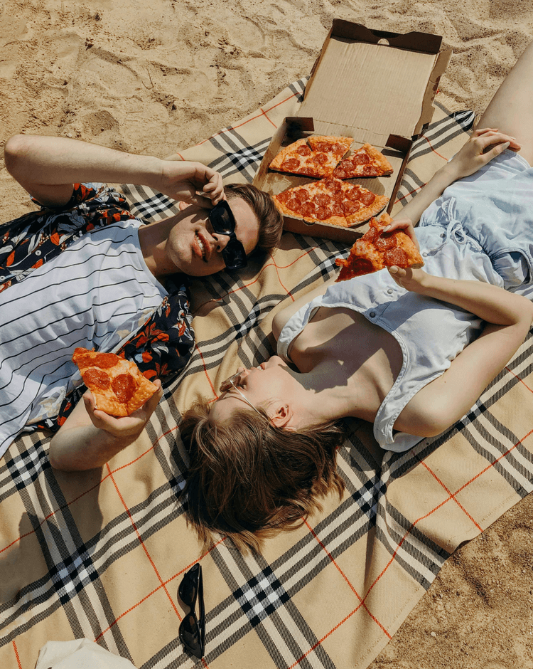 Couple enjoying picnic on beach